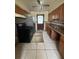 Galley kitchen with wood cabinets and appliances at 411 S Orleans Ave, Tampa, FL 33606