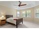 Bright bedroom with large windows and dark wood furniture at 3320 Majestic View Dr, Lutz, FL 33558