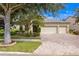 House exterior features a two-car garage and well-manicured landscaping at 3320 Majestic View Dr, Lutz, FL 33558