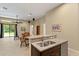 Open kitchen with breakfast bar and view into living room at 3320 Majestic View Dr, Lutz, FL 33558