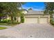 Two-story house with three-car garage and nicely landscaped front yard at 3320 Majestic View Dr, Lutz, FL 33558