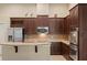 Spacious kitchen with granite countertops and dark wood cabinets at 3320 Majestic View Dr, Lutz, FL 33558