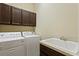 Laundry room with washer, dryer, and additional sink at 3320 Majestic View Dr, Lutz, FL 33558