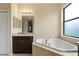 Relaxing bathroom with corner soaking tub and dark brown vanity at 3320 Majestic View Dr, Lutz, FL 33558