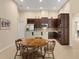 Kitchen boasts dark wood cabinetry, stainless steel appliances, and a breakfast nook at 3320 Majestic View Dr, Lutz, FL 33558
