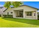 House exterior with covered patio, manicured lawn, and mature trees at 3320 Majestic View Dr, Lutz, FL 33558
