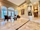 Spacious living room with marble floors and seating area at 168 Rue Des Chateaux, Tarpon Springs, FL 34688