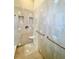 Walk-in shower with tiled walls and grab bars at 168 Rue Des Chateaux, Tarpon Springs, FL 34688