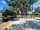 Expansive driveway, basketball court, and tranquil pond view at 168 Rue Des Chateaux, Tarpon Springs, FL 34688