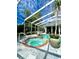 Screened spa with flagstone patio and lush greenery at 168 Rue Des Chateaux, Tarpon Springs, FL 34688