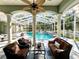 Relaxing pool area with covered patio, seating, and a refreshing pool at 168 Rue Des Chateaux, Tarpon Springs, FL 34688