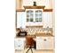 Built-in kitchen desk with granite countertop and glass-front cabinets at 168 Rue Des Chateaux, Tarpon Springs, FL 34688