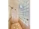 Walk-in shower with glass block wall and seat at 168 Rue Des Chateaux, Tarpon Springs, FL 34688