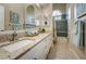 Bathroom with granite countertop, double sinks, and tub at 168 Rue Des Chateaux, Tarpon Springs, FL 34688