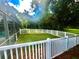 Small fenced backyard with grassy area, adjacent to the pool at 168 Rue Des Chateaux, Tarpon Springs, FL 34688