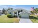 Single story house with a light green exterior and two car garage at 1002 Pondview Ct, Tarpon Springs, FL 34689