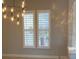 Dining room with plantation shutters and chandelier at 11919 Royce Waterford Cir, Tampa, FL 33626