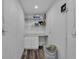 Bright laundry room featuring shelving, storage cabinets, countertop, and a laundry hamper at 12020 82Nd E St, Parrish, FL 34219