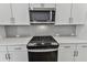 Sleek kitchen with stainless steel appliances and gray backsplash at 445 31St N Way, St Petersburg, FL 33713