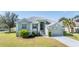 Single-story house with a two-car garage and manicured lawn at 1002 Pondview Ct, Tarpon Springs, FL 34689