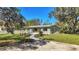 Newly renovated home with a modern facade and landscaped front yard at 12020 82Nd E St, Parrish, FL 34219