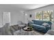 Bright living room with hardwood floors, comfy seating, and a view to the backyard at 12020 82Nd E St, Parrish, FL 34219
