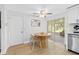 Bright dining area with wood table and wicker chairs, near kitchen and backyard access at 206 Lexington St, Oldsmar, FL 34677