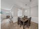 Bright dining area features a table for four and adjacent kitchen views at 8720 Savory Walk Dr, Land O Lakes, FL 34637