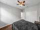 Bedroom with wood flooring, ceiling fan and a double door closet at 8720 Savory Walk Dr, Land O Lakes, FL 34637