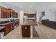 Bright kitchen with an island and a view into the adjacent dining area at 8720 Savory Walk Dr, Land O Lakes, FL 34637