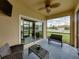 Screened porch with wicker furniture and backyard view at 8720 Savory Walk Dr, Land O Lakes, FL 34637