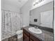 Clean bathroom, shower/tub combo, vanity with granite countertop at 8720 Savory Walk Dr, Land O Lakes, FL 34637