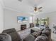 Comfortable living room with sectional sofa and sliding glass doors at 8720 Savory Walk Dr, Land O Lakes, FL 34637