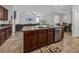 Open kitchen features an island with seating and views into the living room at 8720 Savory Walk Dr, Land O Lakes, FL 34637