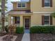 Inviting exterior of a two-story house with a brown door and landscaping at 8720 Savory Walk Dr, Land O Lakes, FL 34637