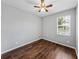 Simple bedroom with wood flooring and a window with blinds at 8720 Savory Walk Dr, Land O Lakes, FL 34637