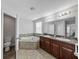 Bathroom with corner tub, double vanity and toilet at 8720 Savory Walk Dr, Land O Lakes, FL 34637