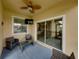 Relaxing screened porch with wicker furniture and ceiling fan at 8720 Savory Walk Dr, Land O Lakes, FL 34637