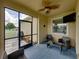 Cozy screened porch with wicker furniture and TV at 8720 Savory Walk Dr, Land O Lakes, FL 34637