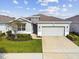 Single-Gathering home with gray siding and a two-car garage at 13204 Waterleaf Garden Cir, Riverview, FL 33579