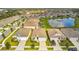 Aerial view of houses and a pond in a residential community at 13204 Waterleaf Garden Cir, Riverview, FL 33579