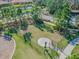 Community dog park with fenced area, agility equipment, and walking paths at 13204 Waterleaf Garden Cir, Riverview, FL 33579