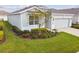 Single-Gathering home with gray siding and landscaping at 13204 Waterleaf Garden Cir, Riverview, FL 33579