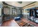 Small bedroom with hardwood floors, stained glass window, and a clothing rack at 14180 W Parsley Dr, Madeira Beach, FL 33708