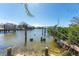 View of calm waterway with boats and damaged dock at 14180 W Parsley Dr, Madeira Beach, FL 33708