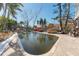 Kidney-shaped pool with damaged surrounding area and debris at 14180 W Parsley Dr, Madeira Beach, FL 33708