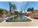Kidney-shaped pool with damaged surrounding area and debris at 14180 W Parsley Dr, Madeira Beach, FL 33708