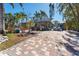 Brick paved front yard with tropical landscaping at 14180 W Parsley Dr, Madeira Beach, FL 33708