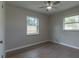 Bright bedroom with wood-look floors and two windows at 1328 Barry St, Clearwater, FL 33756