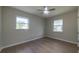 Well-lit bedroom featuring wood-look floors and two windows at 1328 Barry St, Clearwater, FL 33756